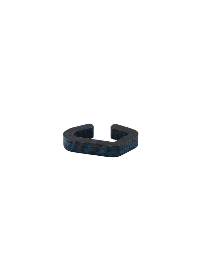STRUGA carbon ear cuff in Arctic Graphite — matte black carbon with blue patches, layers visible along the milled edge