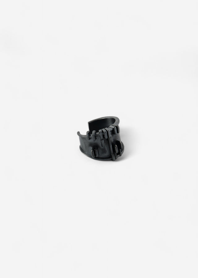 Blackened 925 silver ear cuff on white: open band with flat stepped bars, gap between the ends — STRUGA BRUTALISM V.3.
